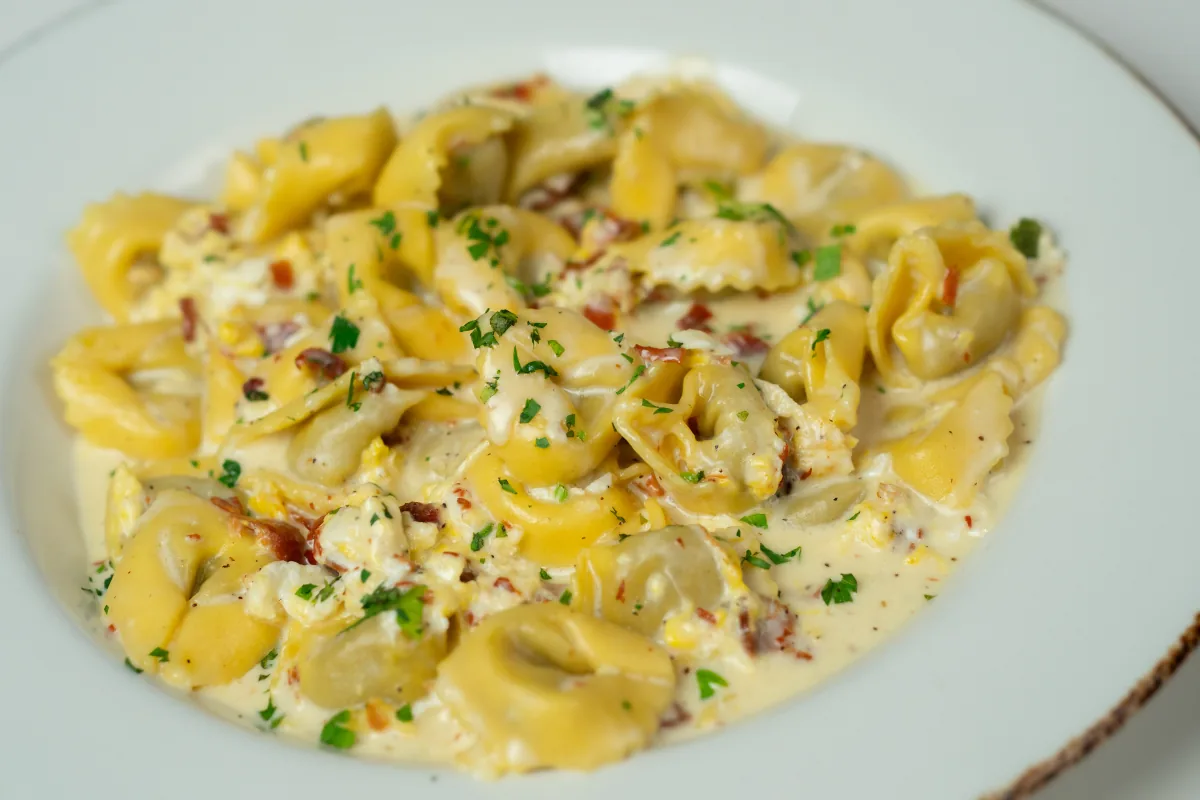 Cheese tortellini in a creamy sauce with herbs